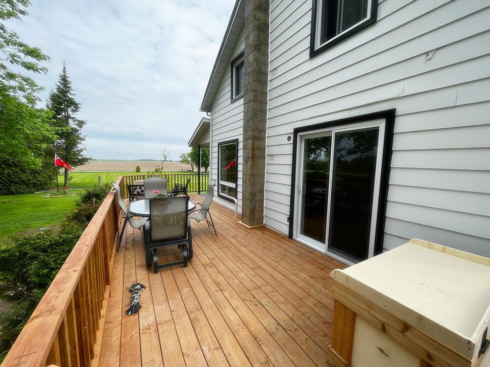 a nice view of a house deck with lawn
